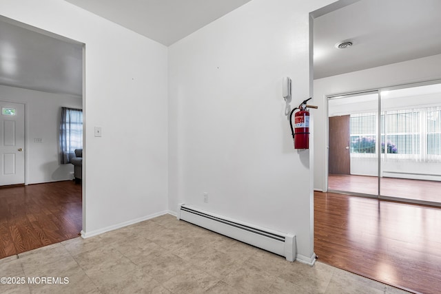 32 Bugle Ct, Toms River, NJ 08757 - tiled empty room with baseboard heating and baseboards