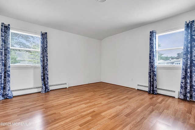 32 Bugle Ct, Toms River, NJ 08757 - empty room with light wood-type flooring, plenty of natural light, and a baseboard heating unit