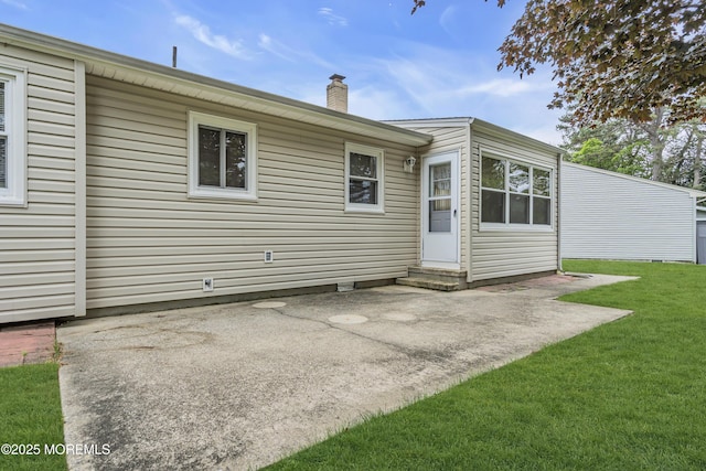 32 Bugle Ct, Toms River, NJ 08757 - rear view of property featuring a patio, a lawn, a chimney, and entry steps