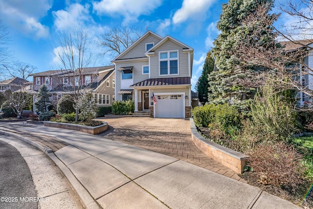 3 Sunset Dr, Asbury Park, NJ 07712 - view of front of property featuring decorative driveway, a garage, a standing seam roof, stone siding, and a residential view