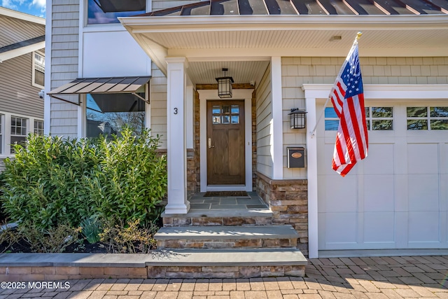 3 Sunset Dr, Asbury Park, NJ 07712 - view of exterior entry with a standing seam roof and stone siding