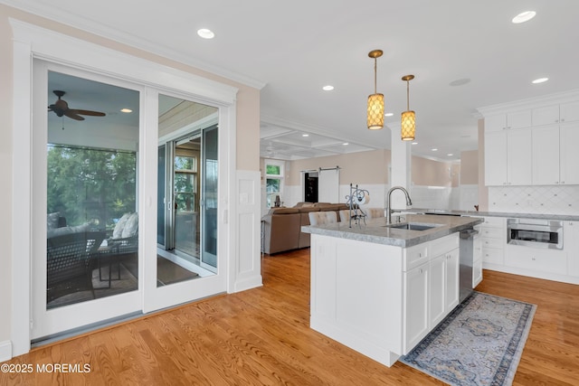 3 Sunset Dr, Asbury Park, NJ 07712 - kitchen with a sink, an island with sink, open floor plan, hanging light fixtures, and white cabinets