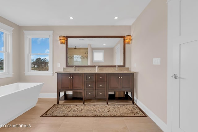 3 Sunset Dr, Asbury Park, NJ 07712 - bathroom featuring double vanity, a freestanding tub, plenty of natural light, tile patterned floors, and recessed lighting