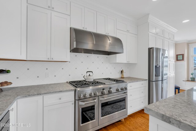 3 Sunset Dr, Asbury Park, NJ 07712 - kitchen with stainless steel appliances, under cabinet range hood, white cabinets, decorative backsplash, and light wood-style floors