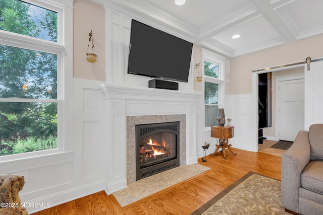 3 Sunset Dr, Asbury Park, NJ 07712 - living room featuring a decorative wall, wood finished floors, a barn door, a fireplace with flush hearth, and beam ceiling