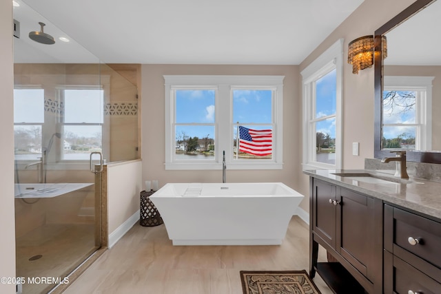 3 Sunset Dr, Asbury Park, NJ 07712 - bathroom with a shower stall, a freestanding bath, baseboards, and vanity