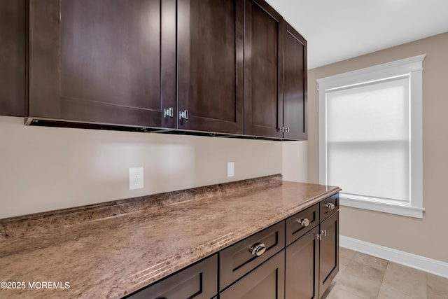 3 Sunset Dr, Asbury Park, NJ 07712 - kitchen featuring baseboards, dark brown cabinets, light stone countertops, and light tile patterned floors