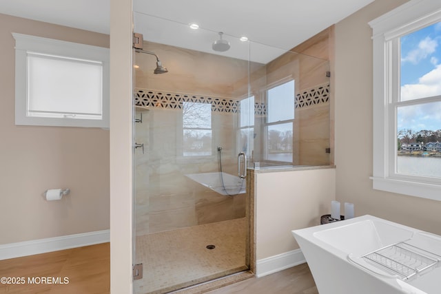 3 Sunset Dr, Asbury Park, NJ 07712 - bathroom featuring a shower stall, a freestanding tub, and baseboards