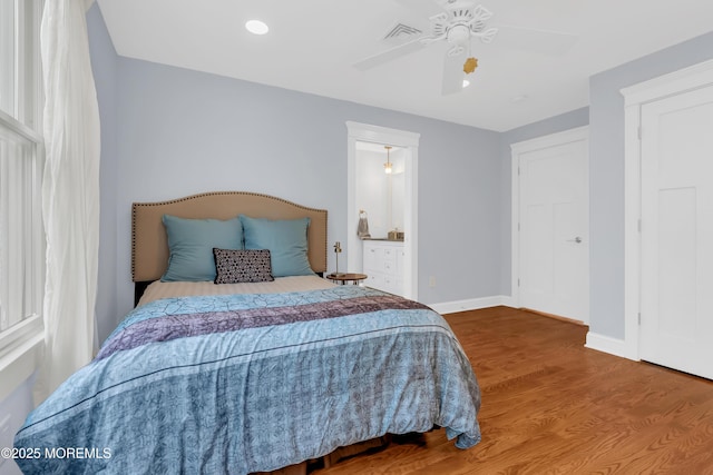 3 Sunset Dr, Asbury Park, NJ 07712 - bedroom with baseboards, wood finished floors, ceiling fan, and connected bathroom