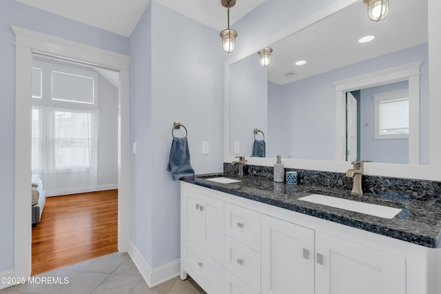 3 Sunset Dr, Asbury Park, NJ 07712 - bathroom with healthy amount of natural light, double vanity, baseboards, and tile patterned flooring