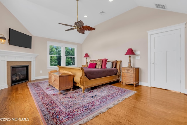 3 Sunset Dr, Asbury Park, NJ 07712 - bedroom featuring vaulted ceiling, light wood-type flooring, a glass covered fireplace, ceiling fan, and recessed lighting