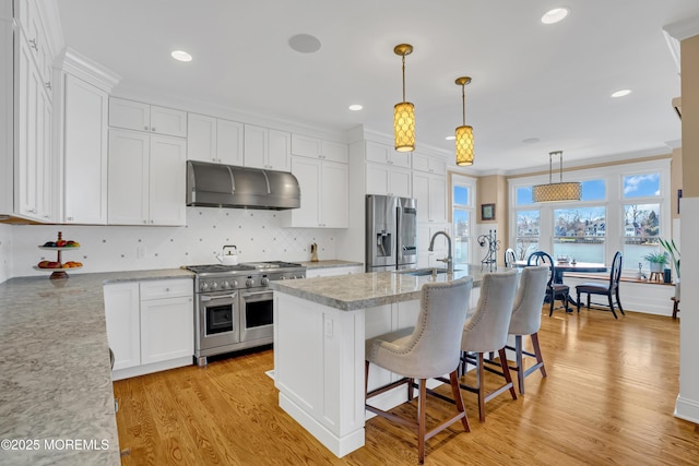 3 Sunset Dr, Asbury Park, NJ 07712 - kitchen with under cabinet range hood, stainless steel appliances, a sink, white cabinetry, and light wood-style floors