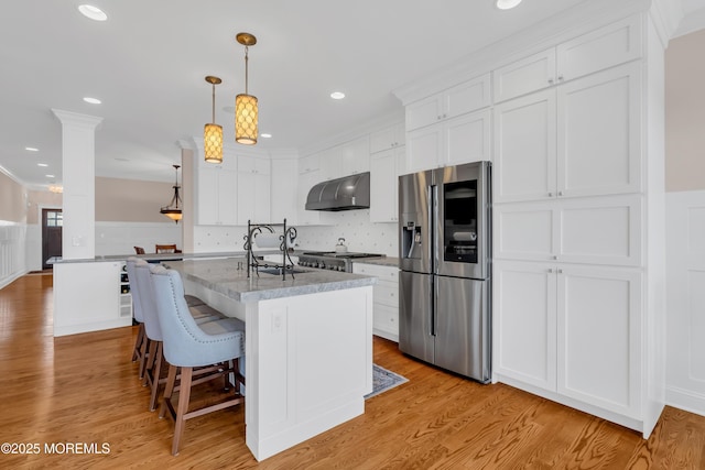 3 Sunset Dr, Asbury Park, NJ 07712 - kitchen with stainless steel refrigerator with ice dispenser, under cabinet range hood, ornate columns, a sink, and white cabinets