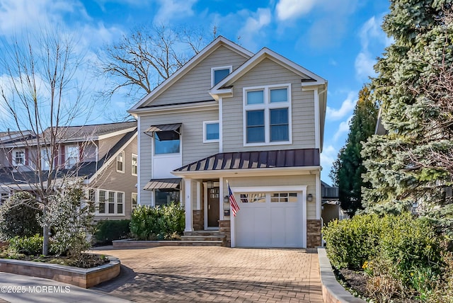 3 Sunset Dr, Asbury Park, NJ 07712 - view of front of property with a standing seam roof, metal roof, decorative driveway, stone siding, and an attached garage