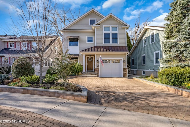 3 Sunset Dr, Asbury Park, NJ 07712 - view of front of property with a standing seam roof, decorative driveway, stone siding, an attached garage, and metal roof