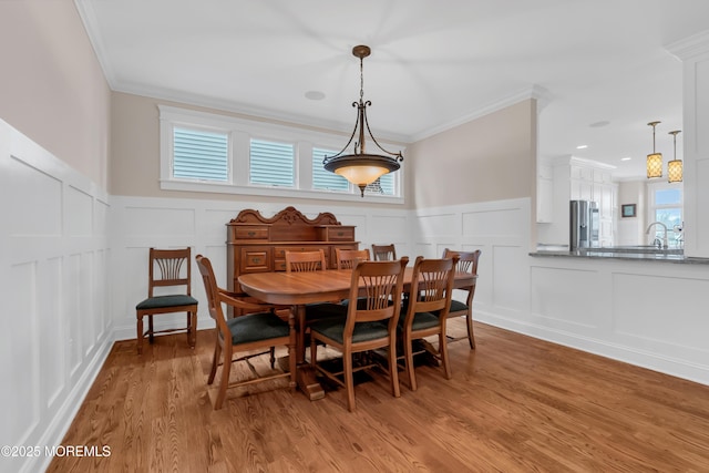 3 Sunset Dr, Asbury Park, NJ 07712 - dining room featuring a decorative wall, ornamental molding, wainscoting, and light wood finished floors