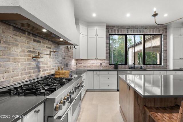 1 Preakness Way, Colts Neck, NJ 07722 - kitchen with appliances with stainless steel finishes, wall chimney exhaust hood, a sink, white cabinetry, and dark countertops