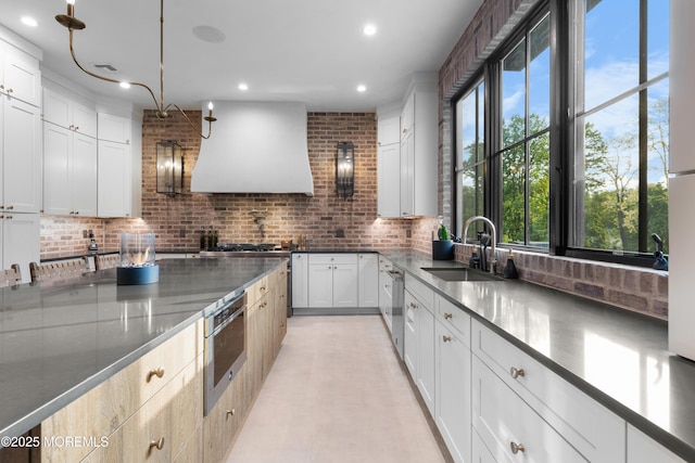 1 Preakness Way, Colts Neck, NJ 07722 - kitchen featuring a sink, custom exhaust hood, healthy amount of natural light, decorative backsplash, and recessed lighting