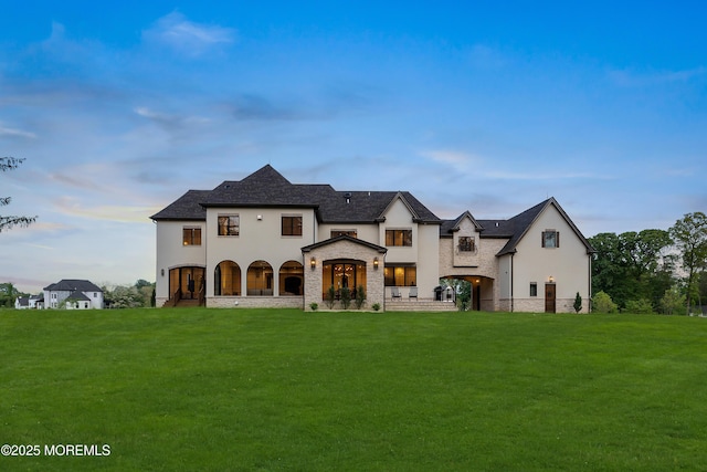 1 Preakness Way, Colts Neck, NJ 07722 - view of front of property with stucco siding, stone siding, a front lawn, and french doors
