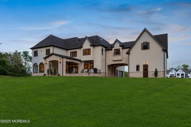 1 Preakness Way, Colts Neck, NJ 07722 - rear view of property with stucco siding, a lawn, and stone siding