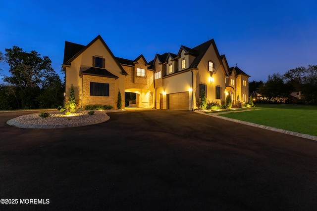 1 Preakness Way, Colts Neck, NJ 07722 - english style home with stucco siding, an attached garage, curved driveway, and a front lawn
