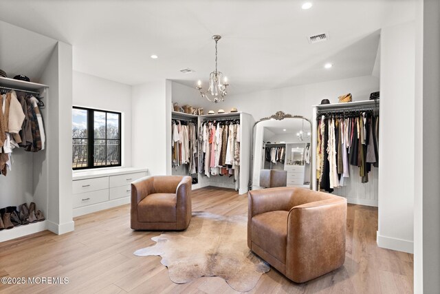 1 Preakness Way, Colts Neck, NJ 07722 - walk in closet featuring a chandelier, light wood-style flooring, and arched walkways