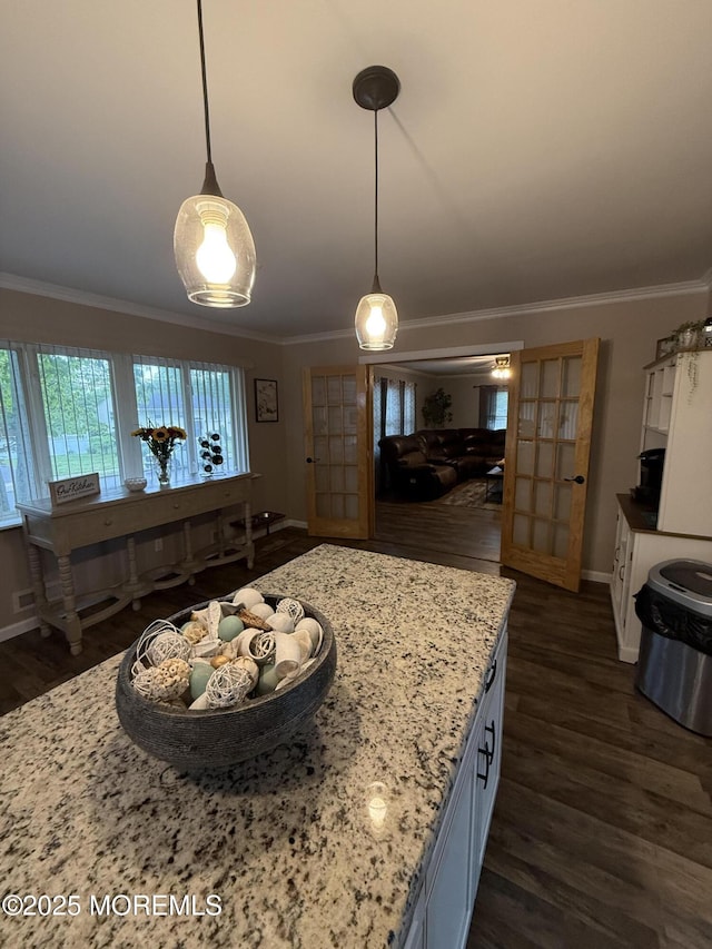 kitchen featuring crown molding, dark wood finished floors, healthy amount of natural light, and baseboards