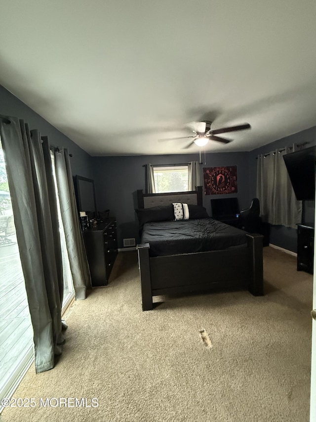 bedroom with light colored carpet and a ceiling fan