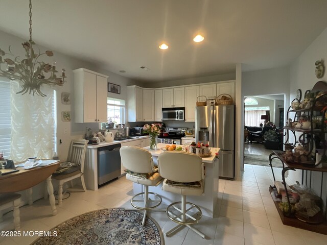 6 Ravenna Rd, Manchester, NJ 08759 - kitchen with stainless steel appliances, white cabinets, a kitchen island, recessed lighting, and a breakfast bar