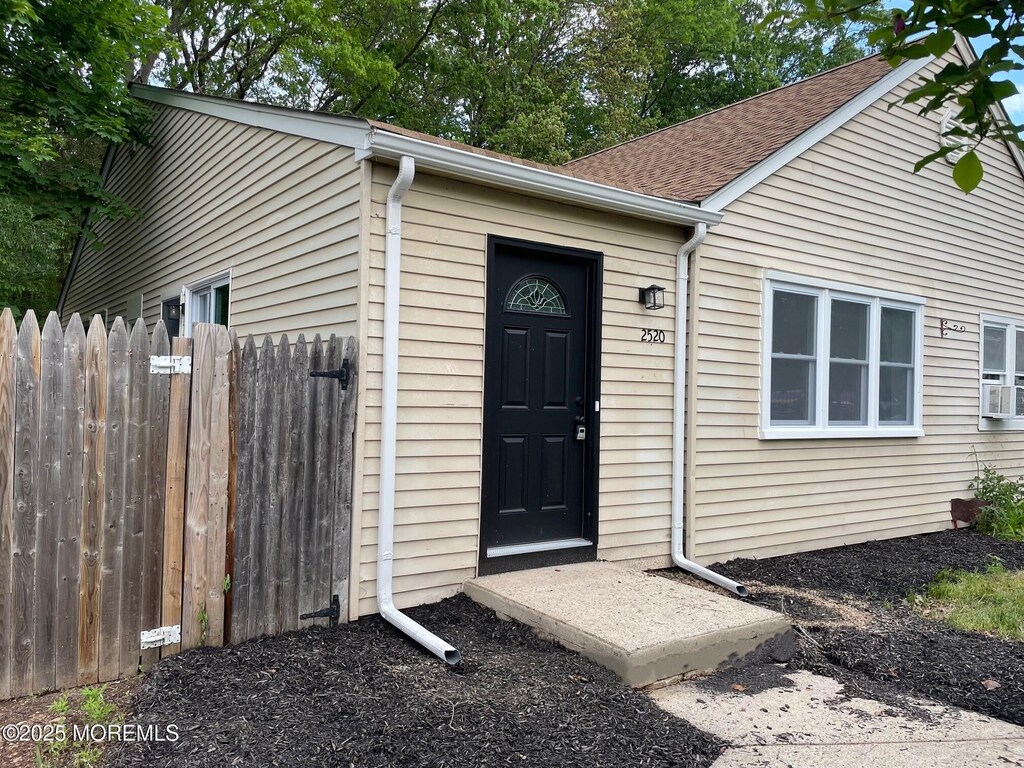 2520 Lexington Ct, Jackson, NJ 08527 - doorway to property with fence and roof with shingles