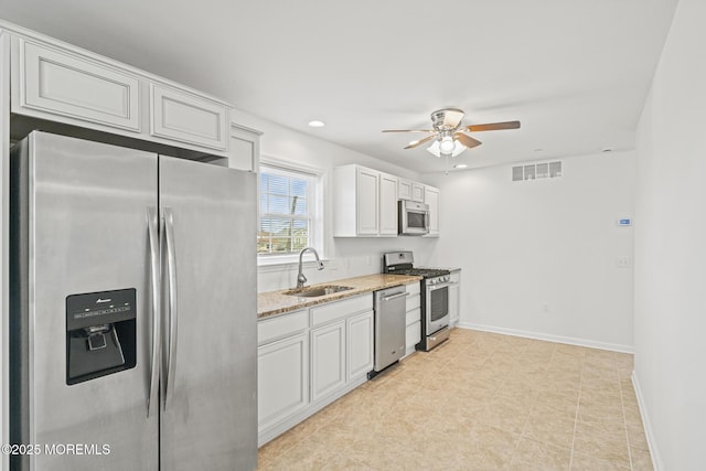 1707 Bay Blvd Unit 4, Seaside Heights, NJ 08751 - kitchen featuring stainless steel appliances, a sink, ceiling fan, light stone counters, and baseboards