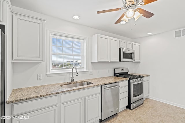 1707 Bay Blvd Unit 4, Seaside Heights, NJ 08751 - kitchen featuring stainless steel appliances, a sink, ceiling fan, white cabinetry, and light stone counters