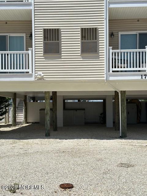 1707 Bay Blvd Unit 4, Seaside Heights, NJ 08751 - view of property exterior with a carport, gravel driveway, and stairway