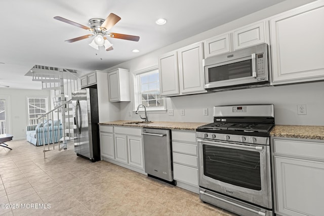 1707 Bay Blvd Unit 4, Seaside Heights, NJ 08751 - kitchen featuring appliances with stainless steel finishes, ceiling fan, white cabinetry, recessed lighting, and light stone counters