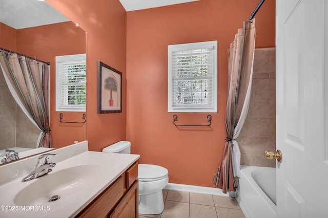full bathroom with plenty of natural light, toilet, tile patterned floors, and vanity