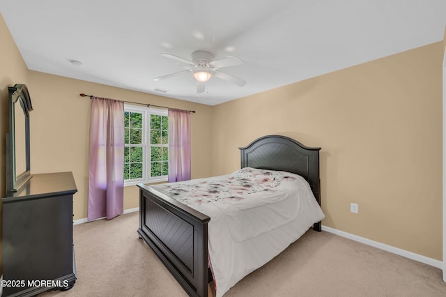bedroom with baseboards, light carpet, and a ceiling fan