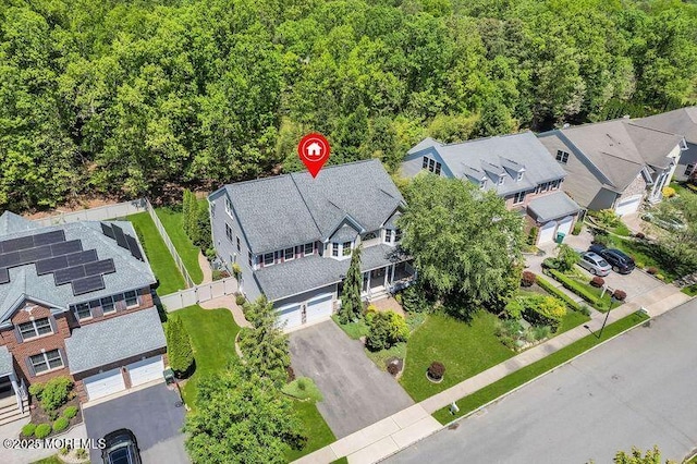 aerial perspective of suburban area featuring a forest