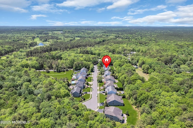 aerial view of residential area featuring a forest