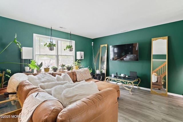 living room with wood finished floors and baseboards