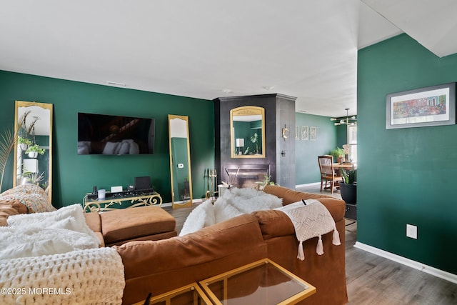 living area featuring baseboards and wood finished floors