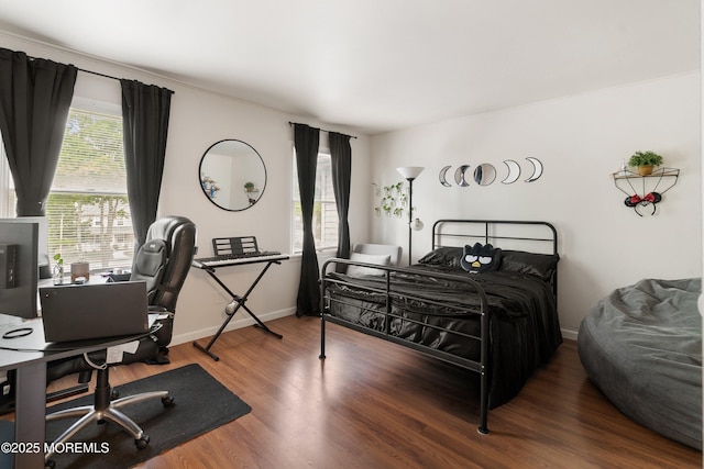 bedroom featuring wood finished floors, a desk, and baseboards