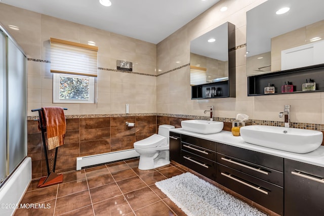 8 Eileen Ln, Marlboro, NJ 07746 - bathroom featuring tile walls, a baseboard heating unit, double vanity, tile patterned floors, and toilet