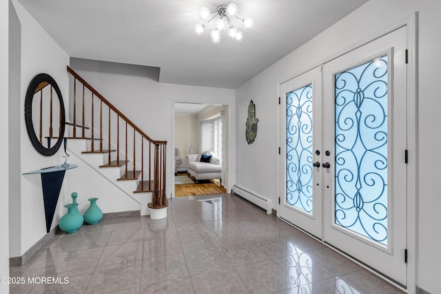 8 Eileen Ln, Marlboro, NJ 07746 - foyer featuring a baseboard heating unit, stairs, french doors, and baseboards