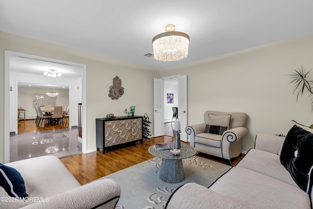 8 Eileen Ln, Marlboro, NJ 07746 - living room featuring a chandelier, wood finished floors, and baseboards