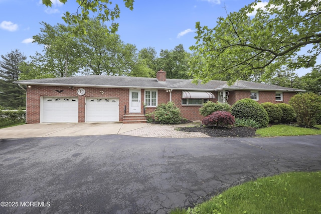 624 Lloyd Rd, Aberdeen, NJ 07747 - ranch-style house featuring driveway, an attached garage, brick siding, and a chimney