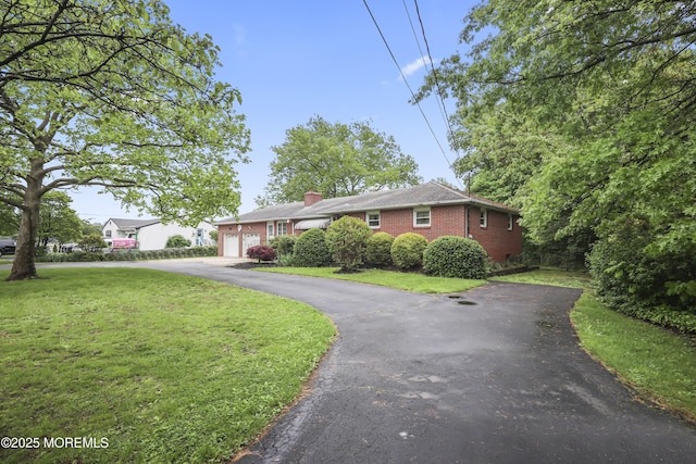 624 Lloyd Rd, Aberdeen, NJ 07747 - ranch-style house featuring driveway, an attached garage, a front lawn, brick siding, and a chimney