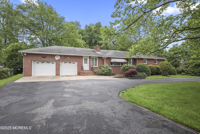 624 Lloyd Rd, Aberdeen, NJ 07747 - view of front of property featuring driveway, a garage, brick siding, and a chimney