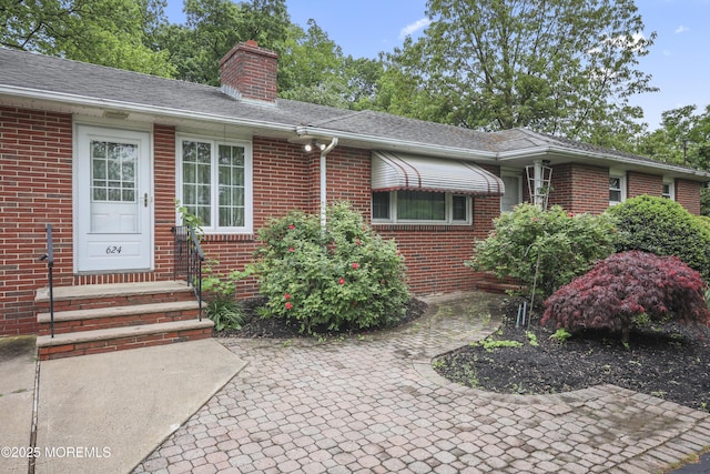 624 Lloyd Rd, Aberdeen, NJ 07747 - view of front of property featuring brick siding, a chimney, roof with shingles, and a patio