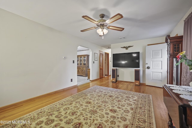 624 Lloyd Rd, Aberdeen, NJ 07747 - living room with arched walkways, ceiling fan, wood finished floors, and baseboards