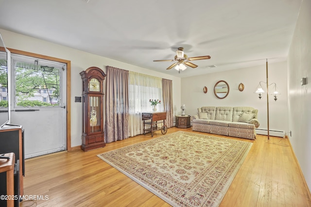 624 Lloyd Rd, Aberdeen, NJ 07747 - living room featuring a baseboard radiator, light wood-style floors, a ceiling fan, and baseboards